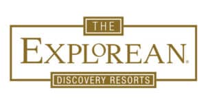 Logo for The Explorean Discovery Resorts, featuring the name in large gold letters with rectangular borders and smaller boxes above and below containing THE and DISCOVERY RESORTS—ideal for Mexico hotels, meetings, and conference events.