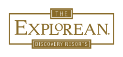 Logo with gold outlined text: THE EXPLOREAN in large font and DISCOVERY RESORTS in smaller font below, all within rectangular borders on a light background—an elegant look perfect for Mexico hotels and conference events.