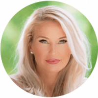 A woman with long blonde hair and light makeup poses in front of a blurred green background, looking directly at the camera.